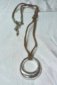 lot 150 image: Rawhide vintage necklace with polished metal elliptical pendant. 16L with 2 extender. Pendant 2L