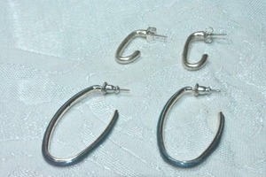 lot 151 image: (2) Modernist open U polished metal poststud earrings 1.75L and 1L