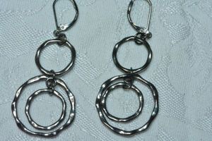 lot 163 image: Dark metal hammered disc dangle lever back earrings. 2.5L