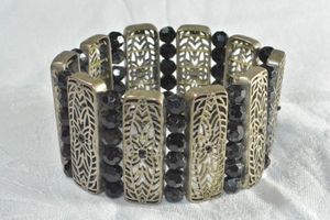 lot 186 image: Industrial bronze finish filigree and black faceted crystal wide stretch bracelet. 1.5W