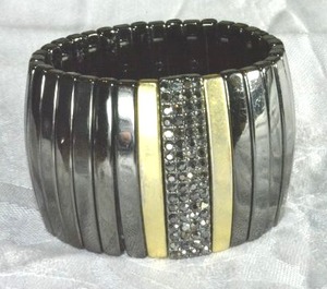 lot 188 image: Signed Kiam Family (Lia Sophia Kiam Family Collection, 2001-2014) industrial burnished metal bar stretch bracelet. Has Kiam Family logo inside. 1.75W