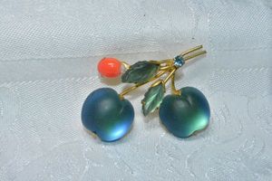 lot 220 image: Austrian frosted satin glass Jelly Belly teal blue figural cherry pin with glass carved leaves. Marked Austria on reverse.