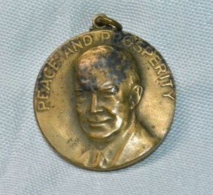 lot 223 image: Solid brass Dwight D. Eisenhower Peace and Prosperity Dinner With IKE 1960 commemorative relief pendant