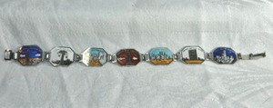 lot 217 image: New York City themed enamel panel bracelet with scenic sites. 7L Fold over clasp
