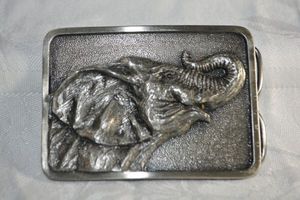 lot 213 image: Buckle Connection raised elephant belt buckle. Marked Northwest Forest Republican Women Club with 1982 in Roman numerals. 3.25W x 2.5H