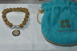 lot 299 image: Signed Rustic Cuff stretch bead bracelet with logo charm in branded keepsake pouch.