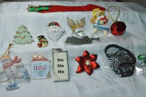 lot 301 image: Holiday jewelry. Includes a fully articulated snowflake pendant necklace, holiday pen, brooches and more