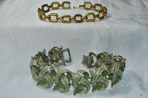 lot 310 image: (2) Signed Coro bracelets. Both marked. Both 7L with fold over clasps. Loss to paint finish on wider bracelet