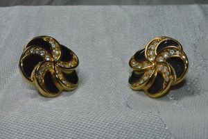 lot 318 image: Signed Swarovski crystal and black enamel poststud earrings. Marked with swan logo on back. Could use cleaning.