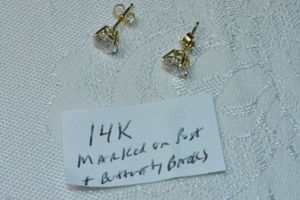 lot 320 image: 14K yellow gold and CZ solitaire stud earrings. Marked 14K on both butterfly backs.