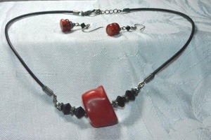 lot 324 image: Artisan crafted red Bamboo Coral pendant on corded 14L necklace with matching Sterling Silver ear wire earrings. 1.5L