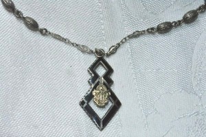 lot 325 image: Sterling Silver Sigma Nu Phi law fraternity (Adelphia Sigma Nu Phi, Wash DC, 1903-1989) enamel pendant on fancy link chain 18L necklace. Spring ring clasp. Pendant 1.5L Marked sterling on reverse.