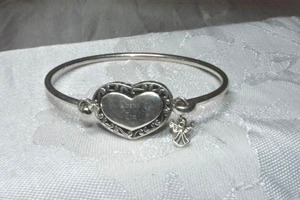 lot 330 image: Sterling Silver AmeriMark tension closure bracelet with heart shaped top. Inscribed with angel charm. Unmarked, but sterling.