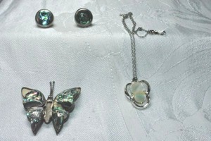 lot 339 image: (3) Sterling Silver shell items. Includes broken abalone shell butterfly pin (Marked Sterling ESC Cuernavaca 925 on reverse, MOP pendant 14L necklace (marked Lang 925 and abalone shell stud earrings. (marked 925)