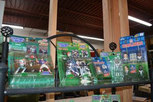 lot 7 image: Football Player figurines still in packages Starting Lineup and NFL Headliners brands. Mostly Dallas Cowboys.
