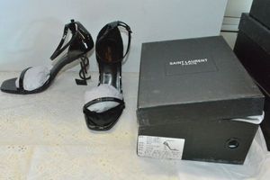 lot 73 image: Saint Laurent Black Patent Shoe with black YSL heel, Marked Saint Laurent Paris made in Italy size 39