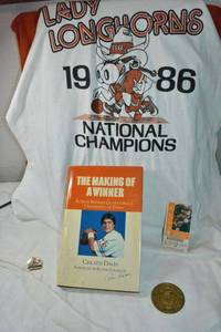 lot 60 image: Univ. of Texas Longhorns Lady T-shirt, The Making of a Winner signed by Roger Staubach, Ticket stub and Championship pin