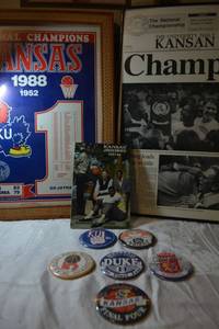 lot 130 image: Kansas Basketball posters from 1988, book and sport buttons