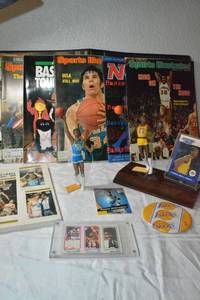 lot 139 image: Kareem Abdul-Jabbar Figurines from UCLA and L.A. Lakers, Basketball magazines and Lakers Button