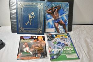 lot 150 image: Emmitt Smith magazines, Earl Campbell 1998 Heisman Figurine, and NFLs Greatest book