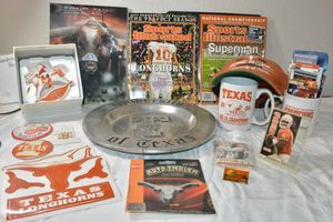 lot 113 image: Univ. of Texas collection Rocking Santa horse, plate, Champs mugs, ball cap, stickers, and magazines