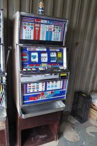 lot 37 image: IGT 25-Cent, 1-to-3 Coin, RED  WHITE BLUE Slot Machine. Lights Up. NOTE Needs Parts And Repair, Bring Help-Very Heavy
