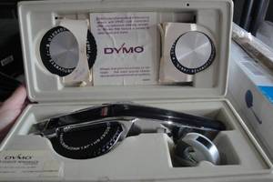 lot 76 image: Dymo Deluxe Tape Writer Kit, #1570, With Interchangeable Embossing Wheels And Roll Of Black Tape, In Case