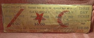 lot 10 image: Cardboard Woodstock Music and Art Festival Ticket Wall Decor---Has some water damage