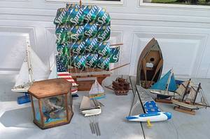 lot 28 image: Large Selection of Boat and Ship Decor Including Metal Santa Boat, Birdhouse and Wind Chime