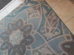 lot 66 image: Turquoise and Grey floral rug ( needs cleaned) 10 12ft8