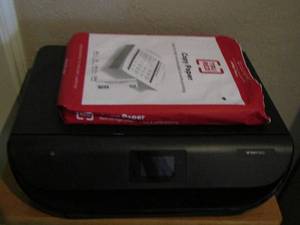 lot 50 image: HP Envy 5052 printer and one opened pack of printer paper