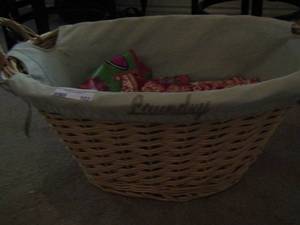 lot 103 image: wicker basket handled , full of cut pieces of fabric