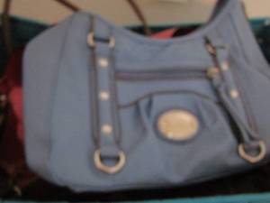 lot 57 image: blue basket of various purses
