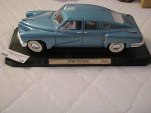 lot 58 image: 1948 Tucker - green Avon bottle