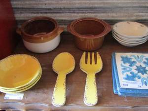 lot 28 image: 3 yellow Tommy Bahama bowls - Tommy Bhamas large spoon & fork- 3 hot pot plates- 4 Oneida cereal bowls, Brown crock