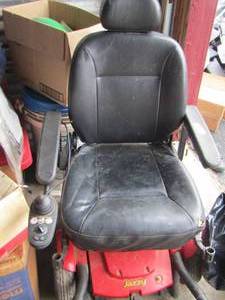 lot 21 image: Jazzy brand scooter chair comes with charger, needs small rips repaired  WORKS