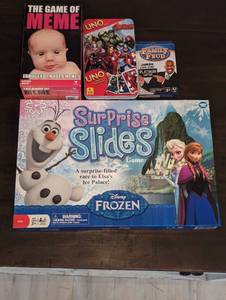lot 83 image: 4 Game Set Disneys Frozen Surprise Slides, Family Feud, The Game of Meme, and Uno Marvel Avengers