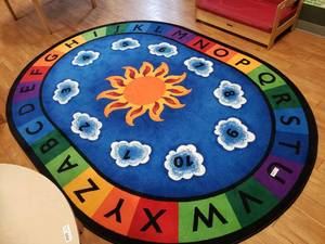 lot 55 image: Large Oval Classroom Rug.  69 x 95