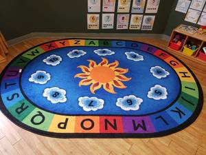 lot 87 image: Large Oval Classroom Rug.  69 x 95