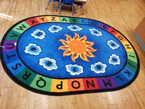lot 110 image: Large Oval Classroom Rug.  69 x 95