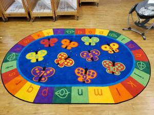 lot 143 image: Large Oval Classroom Rug.  69 x 95