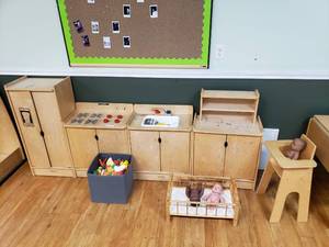 lot 200 image: Large Lot of Kaplan Wooden Kitchen Play Center Items.  Includes Highchair, Hutch, Sink, Stove, Refrigerator, Baby Bed & Container Full of Play Food
