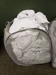 lot 276 image: Laundry Hamper FULL of Approx 35 Crib Mattress Covers