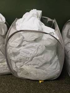 lot 277 image: Laundry Hamper FULL of Approx 35 Crib Mattress Covers