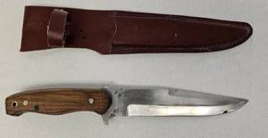 lot 17 image: Walnut handle 12.25 inch custom knife with leather sheath as shown.