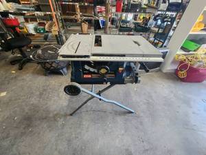 lot 203 image: Ryobi 10 table saw with stand