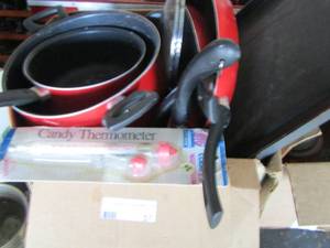 lot 57 image: Preowned red pots and pans also a new candy thermometer