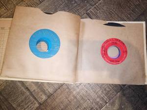 lot 78 image: Vintage collectible 45 RPM records in cream vinyl records book