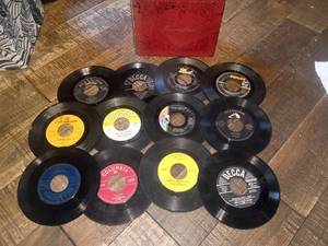 lot 76 image: Vintage collectible 45 RPM records in red vinyl record book