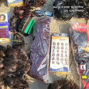 lot 55 image: Large lot of new wigs, Jerry Curls, extensions, weaves and more as shown